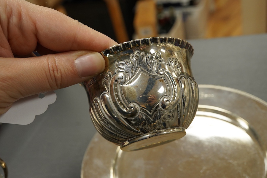 A Victorian silver side plate or stand, by John Edward Bingham (Walker & Hall), Sheffield, 1885, diameter 17.9cm, together with an early 20th century silver cream jug and sugar bowl by Barker Brothers and a Victorian pro